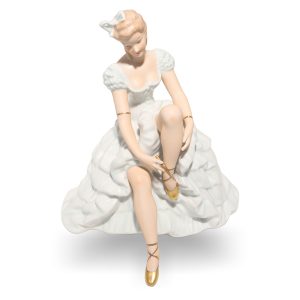 Wallendorf ballerina porcelain figurine tying shoes in white dress with gold ballet slippers, collectible decorative art
